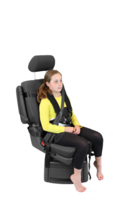 Child secured in a Houdini harness, showing in-flight support for safe, stable postural positioning during air travel.