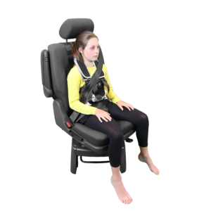 A girl in a yellow shirt secured safely in a vehical seat with a black Houdini 28 anti-escape harness.