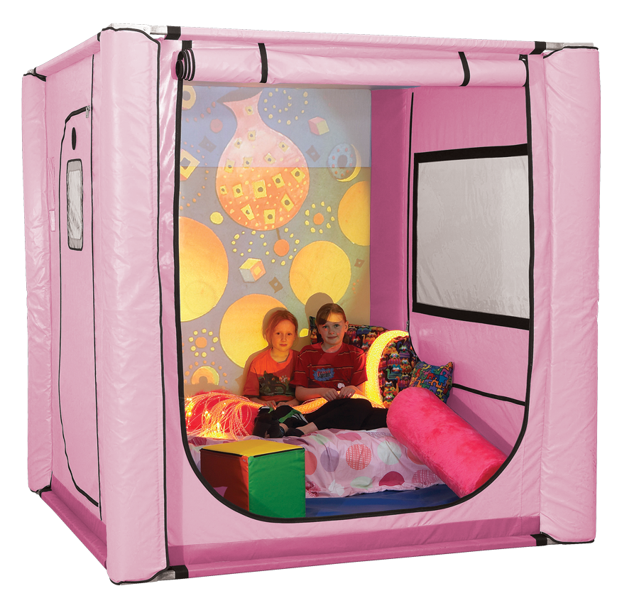 Two young girls sitting on a mattress with cushions and lights inside a pink SafeSpace tent.