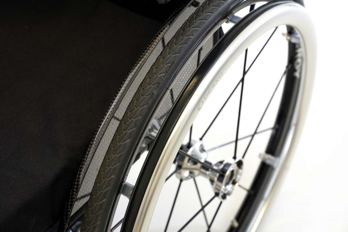 Close up image of wheel rim with silver spokes.