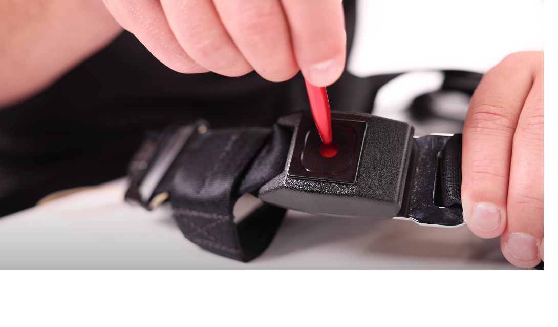 Close up of someone using a Pen Key Release Buckle