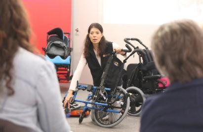 Amy demonstrating a wheelchair at the Medifab Academy