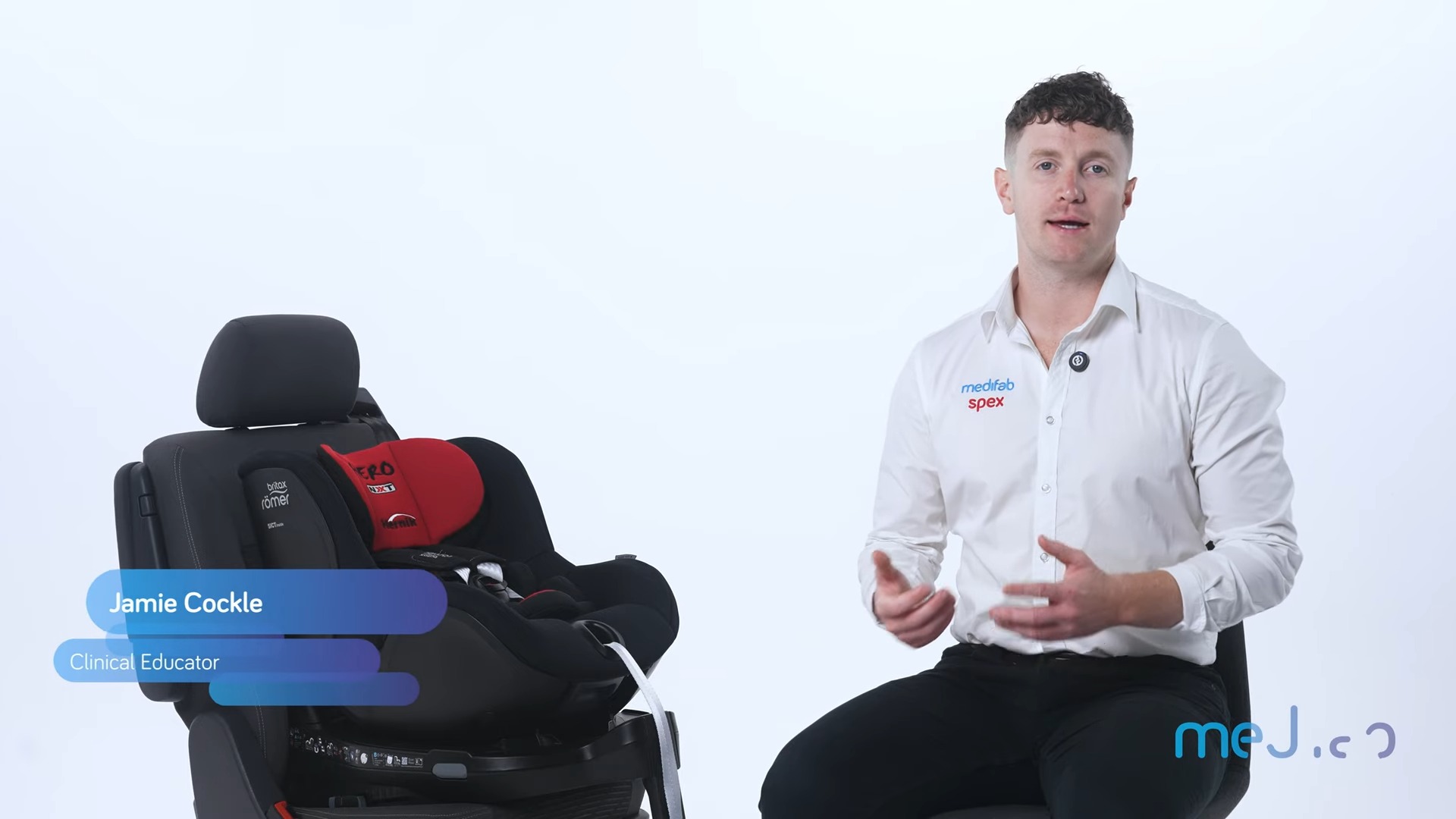 Screengrab from Hero NXT Installation video. Clinical education Jamie Cockle sits next to the Hero NXT Carseat.