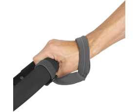 Zoomed in shot of a human hand holding onto a handle with a wrist band attaching to both the handle and the wrist.