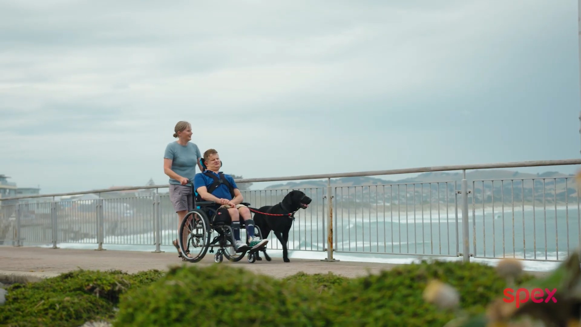 Callum enjoying using his SPEX equipment as he goes for a ride with his dog near the beach