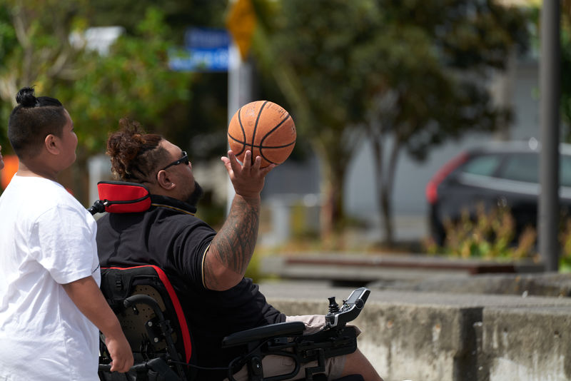 Person playing basketball in a wheelchair