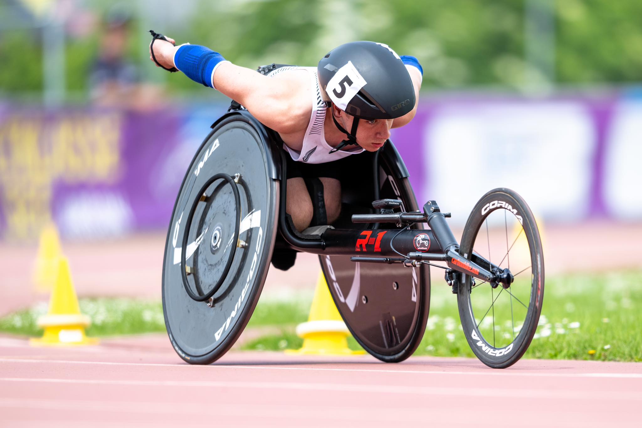 A photo of Paralympian, Jaden Movold during a track race in his wheelchair