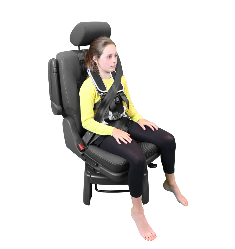 A girl in a yellow shirt secured safely in a vehical seat with a black Houdini 28 anti-escape harness.