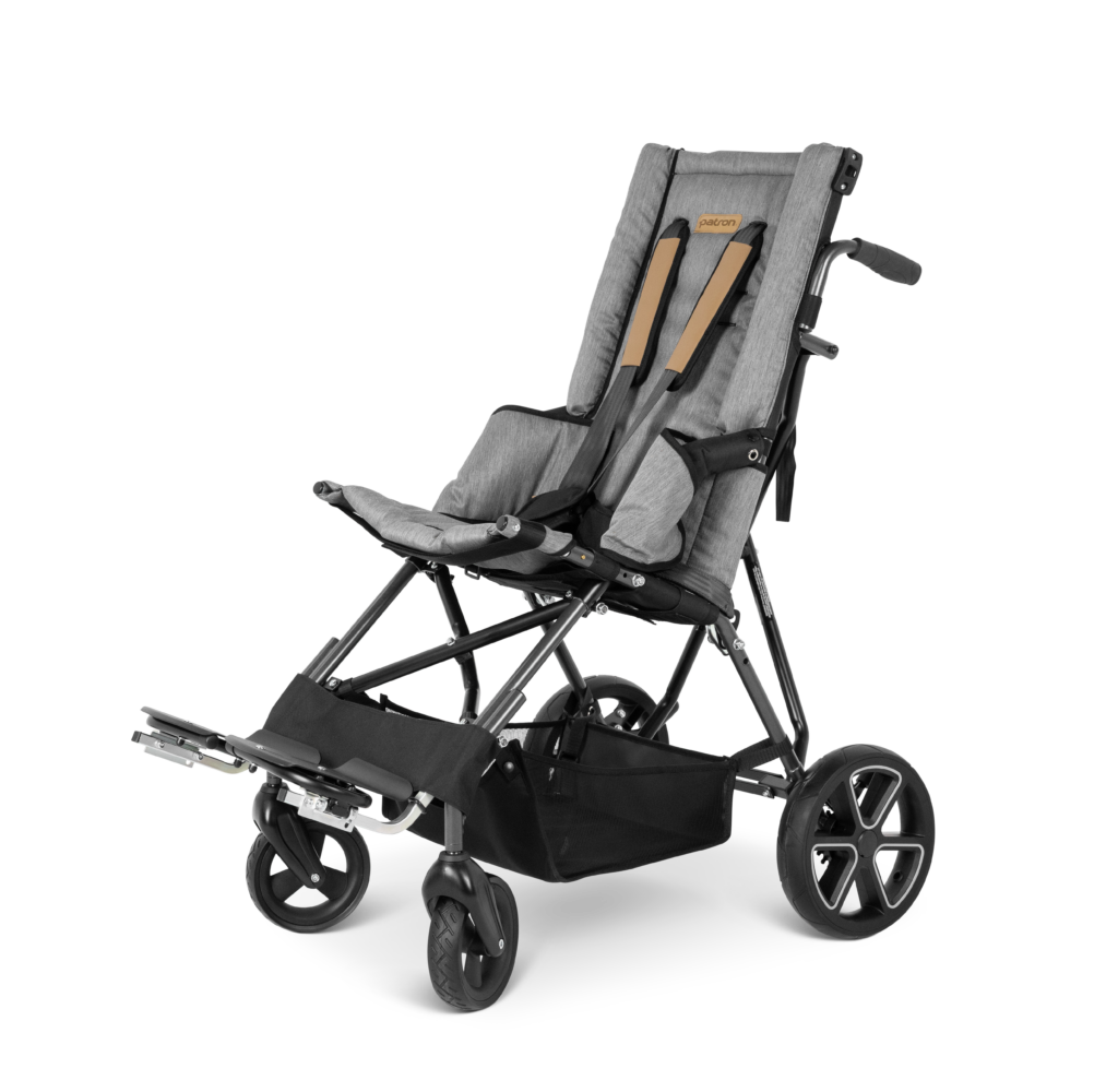 Patron Corzino Stroller on a white background. It has grey upholstery and brown harness, with black frame, wheels and storage basket at the bottom, and shadows. . It is on a diagonal angle facing the left.