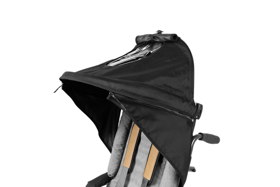 Close up image of black sun canopy attached to patron stroller.
