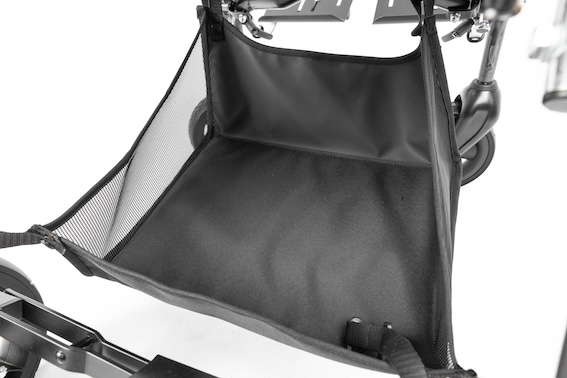 Close up image of a black storage basket with mesh sides, attached to a stroller.