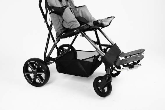 Close up image of a black storage basket with mesh sides, attached to a stroller, showing all wheels, foot support and the seat base.