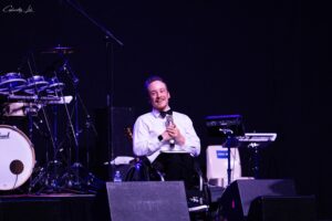 Spex Ambassador Jaden Movold smiling onstage whilst holding a microphone.